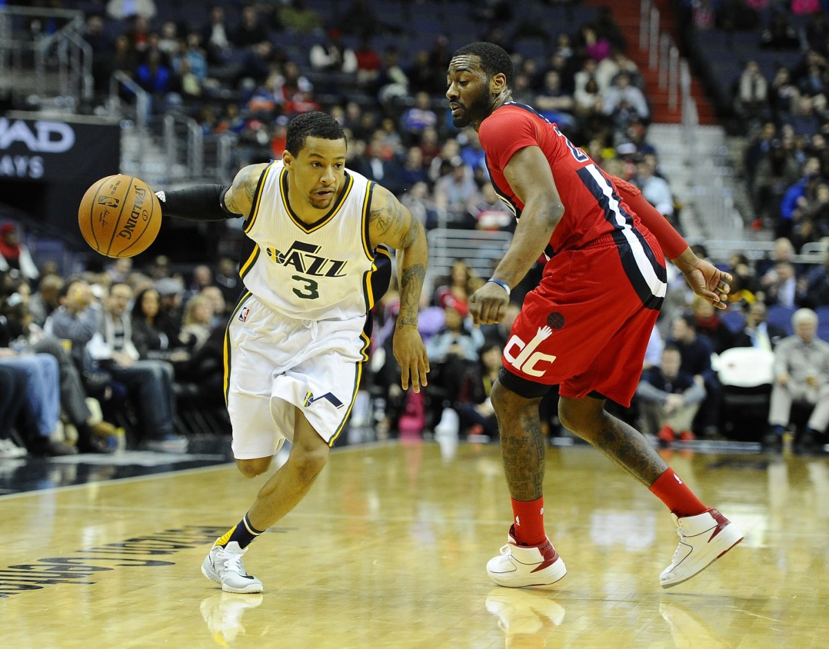 Utah Jazz guard Trey Burke (3) dribbles past Washington Wizards guard John Wall (2) during the second half at Verizon Center. The Washington Wizards won 103-89.